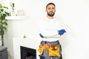 peintre La peinture une maison mur avec une peindre rouleau. photo