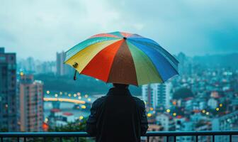 une la personne permanent en dessous de une coloré parapluie photo