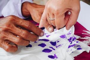 proche en haut portrait de peu doigt plongement dans violet encre après vote pour Indonésie Président et gouvernement élection 2024 photo