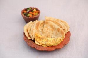 desi petit déjeuner mixte légumes, Oeuf omelette et paratha servi dans plat isolé sur Contexte Haut vue de bangladais petit déjeuner photo
