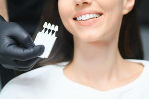 dentiste vérification et sélection Couleur de Jeune femme les dents photo