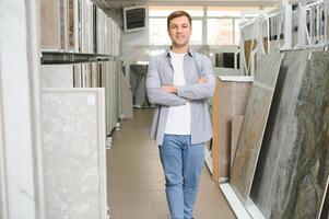 Jeune homme choisir carrelage à bâtiment marché photo