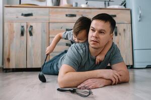 Jeune homme et le sien fils avec four feuille dans cuisine. père avec peu fils sur le cuisine photo