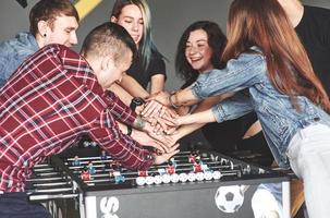 des amis jouent ensemble à des jeux de société, au baby-foot photo