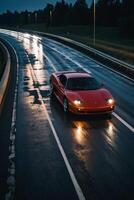 une des sports voiture conduite sur une humide route à nuit photo