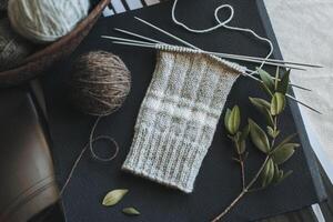 main tricoté chaussettes avec aiguilles et fil des balles. concept pour Fait main et hygge lent vie. photo