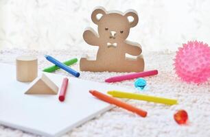 une marron ours est séance suivant à une blanc boîte avec des crayons et Marqueurs. photo