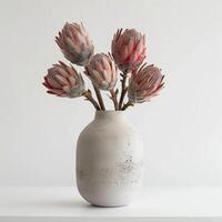 une minimaliste béton vase détient une frappant protea bouquet. photo