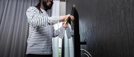 africain américain est nettoyage maison Faire travaux ménagers nettoyage télévision avec chiffon photo