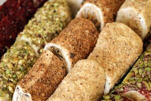 Rouleaux de turc délice avec beaucoup différent les saveurs et plombages proche en haut sur table de vendeurs marché photo