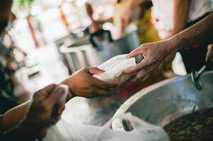 le concept de mendicité et faim. faim problèmes de le pauvres avoir été donné nourriture à réduire faim. le concept de nourriture pénurie dans le monde. faire un don nourriture avec l'amour et espérer à le pauvres photo