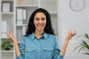 perplexe professionnel femme sur une appel, faire des gestes dans confusion pendant un en ligne réunion à une moderne Accueil bureau. photo