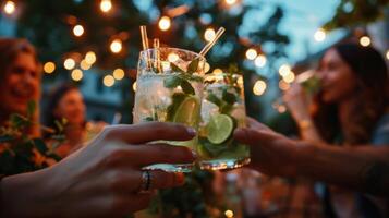 une groupe de gens séance en dessous de cordes de pendaison lumières sirotant sur clair des lunettes rempli avec pétillant sans alcool cocktails sans alcool photo