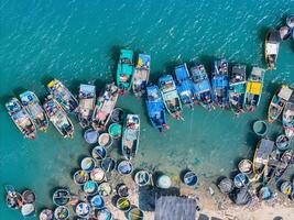 aérien vue de loc un pêche village, vung tau ville. une pêche Port avec tsunami protection béton blocs. paysage urbain et traditionnel bateaux dans le mer. photo