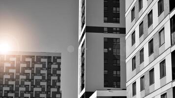 fragment de le bâtiments façade avec les fenêtres et balcons. moderne appartement bâtiments sur une ensoleillé journée. façade de une moderne Résidentiel bâtiment. noir et blanche. photo