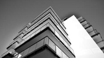 fragment de une façade de une bâtiment avec les fenêtres et balcons. moderne appartement bâtiments sur une ensoleillé journée. façade de une moderne appartement bâtiment. noir et blanche. photo