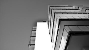 fragment de une façade de une bâtiment avec les fenêtres et balcons. moderne appartement bâtiments sur une ensoleillé journée. façade de une moderne appartement bâtiment. noir et blanche. photo