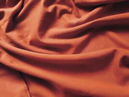 Orange en tissu arrière-plan, soyeux pente luxe en tissu texture, été textile bannière Matériel tropical vague Regardez mode abstrait conception affiche modèle photo