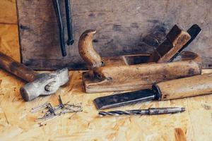 vieux outils de construction sur un établi en bois plat laïc arrière-plan photo