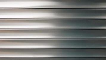 stores à texture ou roleta. stores horizontaux métalliques portes fermées rayé argent. abstrait de texture en métal en aluminium.