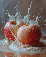 deux rouge pommes avec l'eau éclaboussure sur blanc Contexte. photo