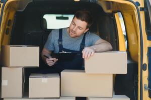 livraison un service employé. portrait de homme travail dans livraison service. portrait de courrier avec boîte. courrier suivant à minibus. livraison un service carrière. photo