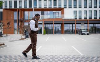 à la mode Masculin modèle dans costume en marchant sur le rue. élégant Beau homme en marchant Extérieur. photo