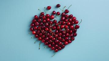 cœur forme fabriqué de mûr Cerise des fruits sur une bleu Contexte. photo