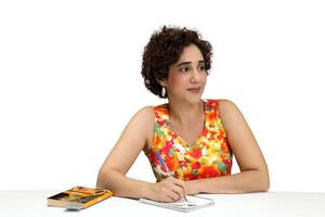 Jeune femme en train de lire et l'écriture à sa bureau photo