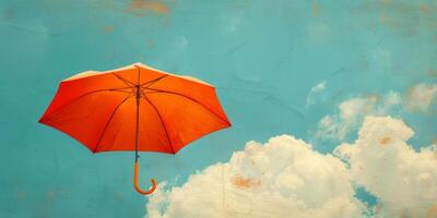 Orange parapluie flottant contre une turquoise ciel avec des nuages photo