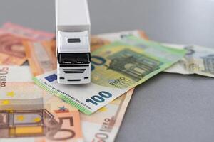 blanc jouet un camion sur euro billets de banque. concept pour logistique, transport et et la finance photo