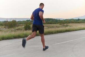 une dévoué marathon coureur pousse lui-même à le limite dans entraînement. photo