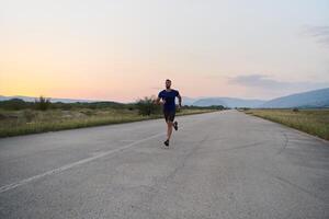 une dévoué marathon coureur pousse lui-même à le limite dans entraînement. photo