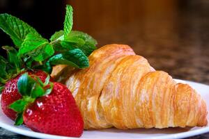 fermer de croissant saupoudré portion cuisinier à Accueil décorer beaucoup différent s avec des fraises et Chocolat saupoudré avec sirop saupoudré avec différent garnitures Photos et s