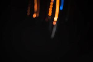 lumière orange traînée flou été abstrait lumières au mouvement tourbillon effet de traînée noir photo