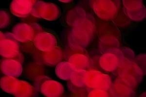 rouge foncé coloré flou ray paillettes flou noël texture lumière résumé photo