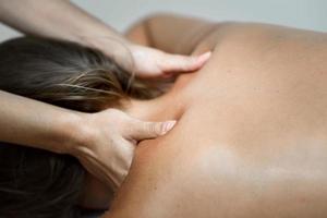 jeune femme recevant un massage du dos dans un centre de spa.