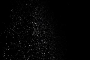 les particules blanches sur fond noir représentant une chute de neige. images de superposition de neige pour donner un effet glacial ou hivernal à la présentation vidéo. photo