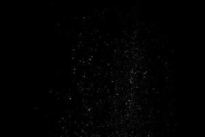 les particules blanches sur fond noir représentant une chute de neige. images de superposition de neige pour donner un effet glacial ou hivernal à la présentation vidéo. photo