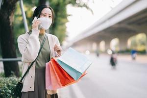 femme asiatique portant un masque en marchant dans la rue photo