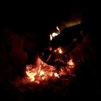 Belle flamme en bois brun charbon noir foncé sur feu jaune vif à l'intérieur d'un brasero en métal photo
