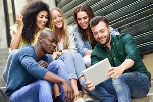 groupe multiethnique de jeunes regardant un ordinateur tablette photo