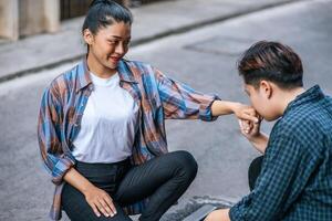 la femme de deux amants s'assit et se baisa la main. photo