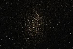 motif abstrait or paillettes stardust lumières étincelantes grunge sur noir. photo