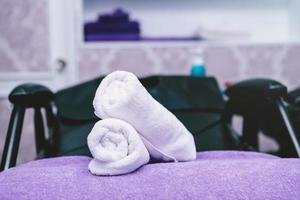 des serviettes de spa turquoise empilent sur des fauteuils avec des lavabos dans un salon de coiffure. photo