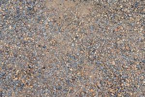 texture colorée de sable ou de galets. texture transparente sur la texture du sol. photo