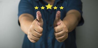 concept de satisfaction client pouce levé icône smiley évaluation 5 étoiles concept positif satisfaction positive sur les produits, services. photo