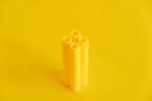 blocs de construction en plastique jaune en forme de tour sur fond jaune photo