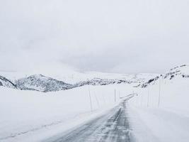 conduire à travers une route enneigée et un paysage en norvège.