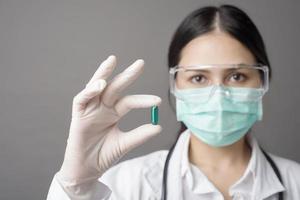 un médecin intelligent tient une pilule médicinale photo